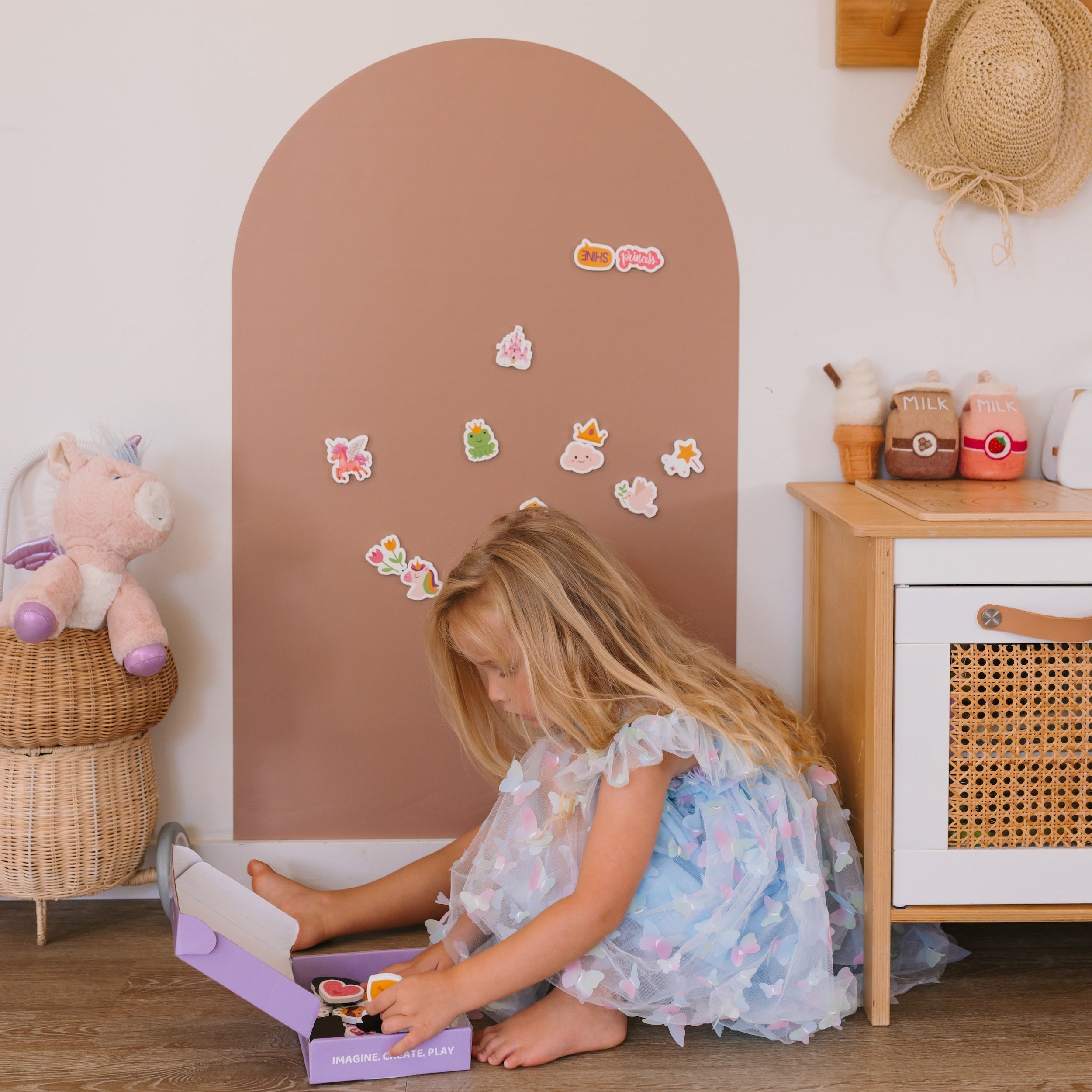 A child playing with colourful magnets on the SmartyPals Magnetic Playwall, a screen-free Christmas gift idea